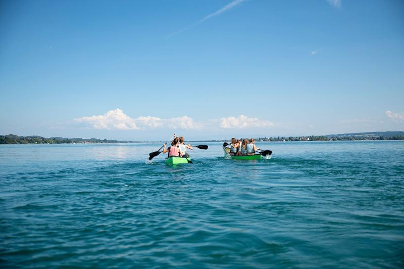 Al campo internazionale sul Lago Costanza ci sono due canoe dove i ragazzi stanno remando nel lago