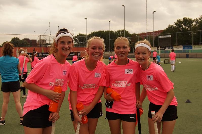 Quattro ragazze della stessa squadra sorridono al estivo internazionale di Hockey a Rotterdam