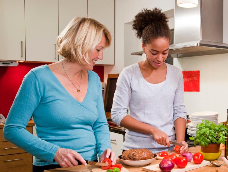 Una ragazza in famiglia ospitante cucina insieme alla sua host mom