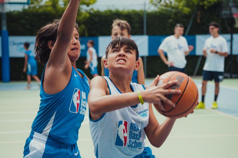 Due ragazzi del campo estivo basket si lottano per il pallone