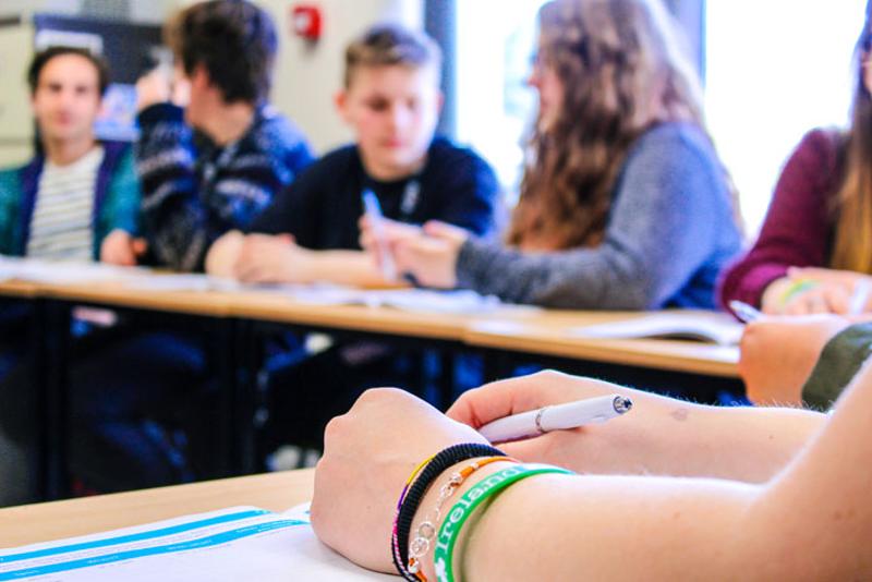 Ragazzi seduti ai banchi che fanno un attività insieme durante una lezione di inglese al soggiorno linguistico Dublino